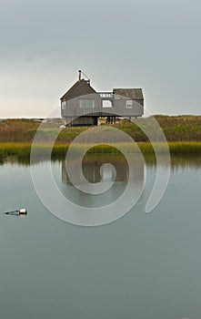 Front view of a Front view of a beach house and reflexion on back day at sunrise