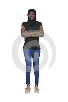 Front view of a full portrait of a woman with burka jeans and sneakers arms crossed