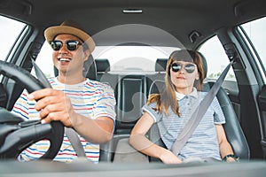 Front view of Funny moment couple asian man and woman sitting in car. Enjoying travel concept.