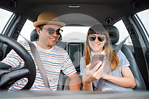 Front view of Funny moment couple asian man and woman sitting in car. Enjoying travel concept.