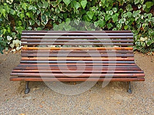 Front view of garden bench with iron legs. Park and garden furniture. Outdoor wrought iron bench