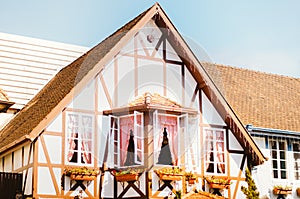 Front view of a gorgeous colonial german house and its windows decorated with flowers in Vila GermÃ¢nica, Blumenau - Brazil during