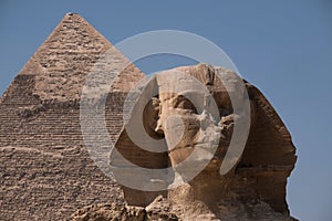 Front view of the Great Sphinx Giza and the Great Pyramid in Egypt under blue sky