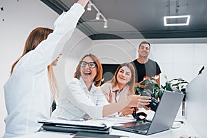 Front view of group of business people in formal clothes working indoors in the office