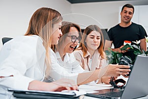 Front view of group of business people in formal clothes working indoors in the office