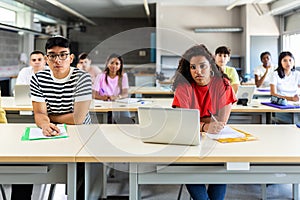 Group of multiracial students listening teacher at school classroom lesson