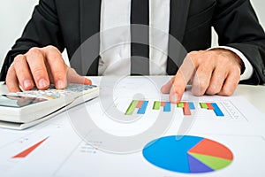 Front view of the hands of a accountant analysing a bar graph