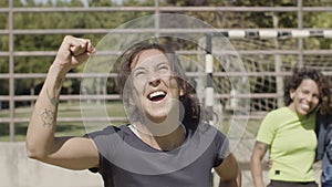 Front view of happy female football player rejoicing victory