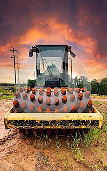 Front View: Heavy construction vehicle of a Sheepsfoot Roller Drum for compacting soil.