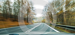 Front view of the highway road passing the country side inside the fast car long exposure shoot