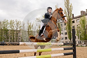 Front view of horse and rider executing jump