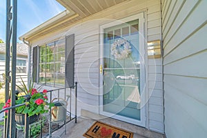 Front view of house on real estate listing with glass storm door and green door