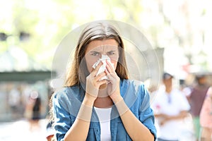 Ill woman blowing mucus looking at camera photo