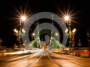 Front view of illuminated Liberty bridge in Budapest, Hungary. Night shot long exposure with car lights