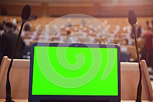 Front view of the laptop and microphones during business conference in conference room or hall, panel duscusion of economic