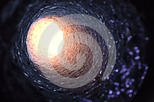 Front view looking inside a flexible pipe with thermal fiberglass insulation wrapping