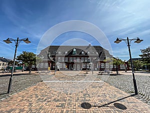 Front view of the main station and the station forecourt in Westerland on Sylt during a sunny day photo