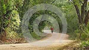 Front view of male cycling in countryside on speed.