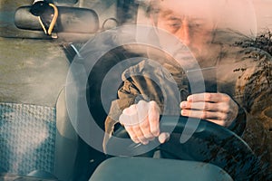 Front view of man driving car and texting on mobile