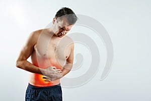 Front view, the man holds his hands to the stomach, abdominal pain