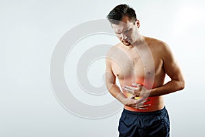 Front view, the man holds his hands to the stomach, abdominal pain, pain in the stomach highlighted in red.