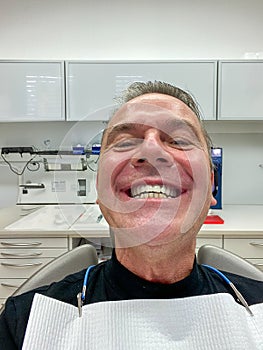 Front view of a man showing his new teeth