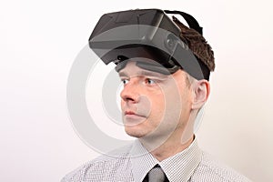 Front view of a man wearing a VR Virtual reality Oculus Rift 3D headset, face looking left