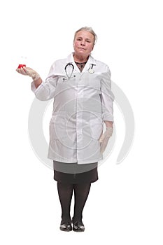 Front view of a mature scientist or doctor tudying the red liquid in the beaker