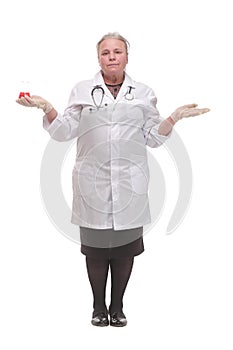 Front view of a mature scientist or doctor tudying the red liquid in the beaker
