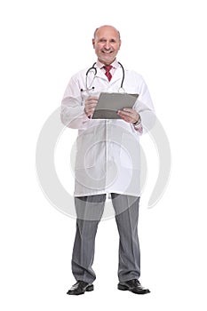 Front view of mature serious doctor writing on clipboard