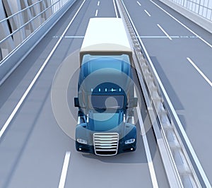 Front view of metallic blue Fuel Cell Powered American Truck driving on highway