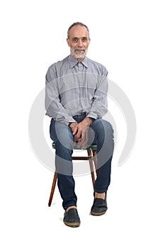 front view of a middle aged man sitting on chair serious and looking at camera