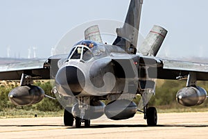 Military bomber fighter jet aircraft taxiing on an airbase photo