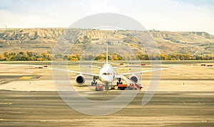 Front view of modern airplane at terminal gate ready for takeoff