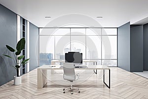 Front view of modern empty office interior with wooden floor, dark walls and desks with computers, window with city view and