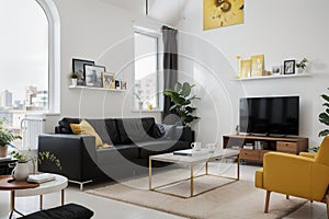 Front view of modern living room interior with one empty poster on white wall, mock up. Furnished by yellow armchair, coffee table
