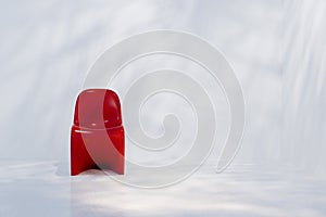 Front view of modern red chair in minimalist setting