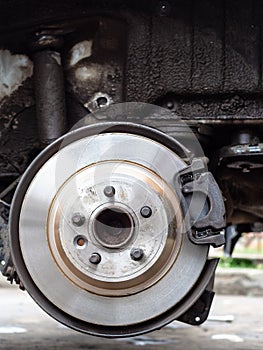 Front view of new brake disc on old vehicle