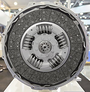 Front view of new composite clutch disc inside open housing for trucks and tractors. New friction pads. Clutch repair kit. Car mai