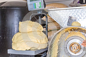 Front view of a nixtamal mill and a scale weighing dough photo