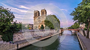 Front view of Notre Dame De Paris cathedral day to night timelapse after sunset.