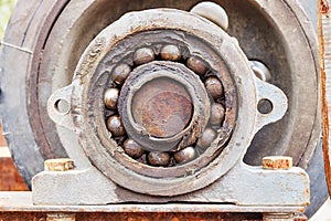 Front view of an old bearing on a shaft with old grease