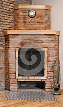 Old brick fireplace with black doors