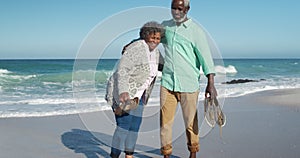 Front view old couple standing together at the beach