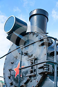 Front view of an old-fashioned steam locomotive.
