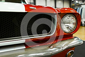 Front view of a old retro car. Car exterior details. Headlight of a vintage retro car. The front lights of the car.