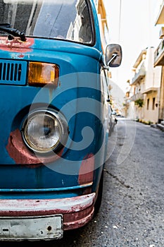 Front view of old rusty blue vintage van. headlights front of car