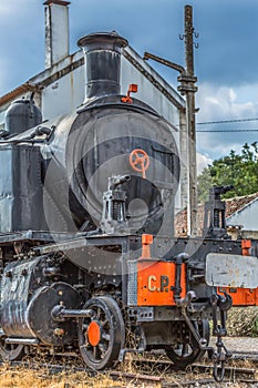 Front view of old train with dramatic sky