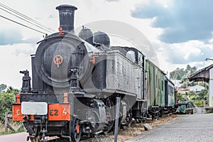 Front view of old train with dramatic sky