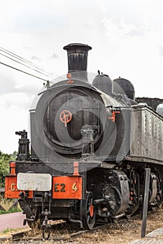 Front view of old train with dramatic sky